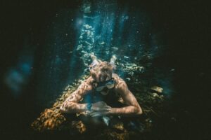  A diver looking at fish, wearing a TAG Heuer Watch